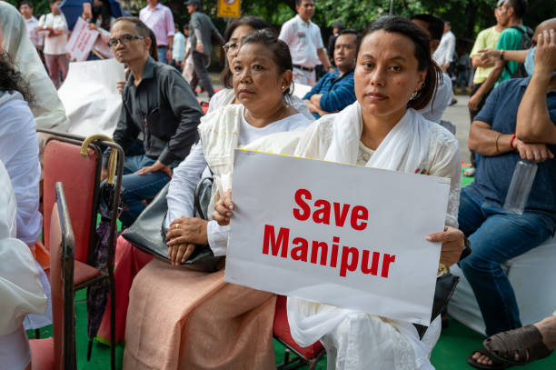 A Manipur girl Protest against Violence with Play Card save Manipur