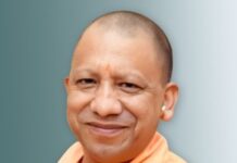 Up cm yogi Adityanath smiling wrapped in saffron clothes