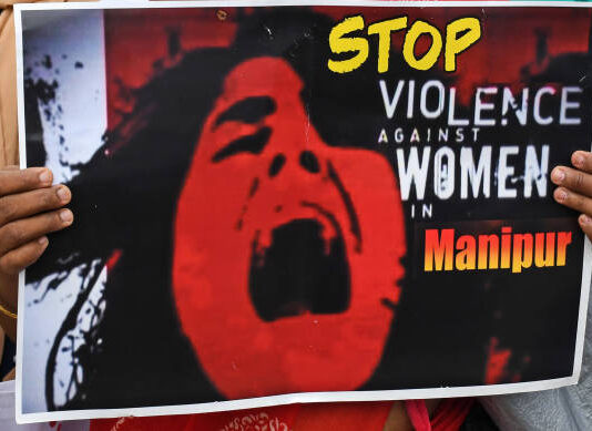 Manipur girl crying with a playcard written stop Violence
