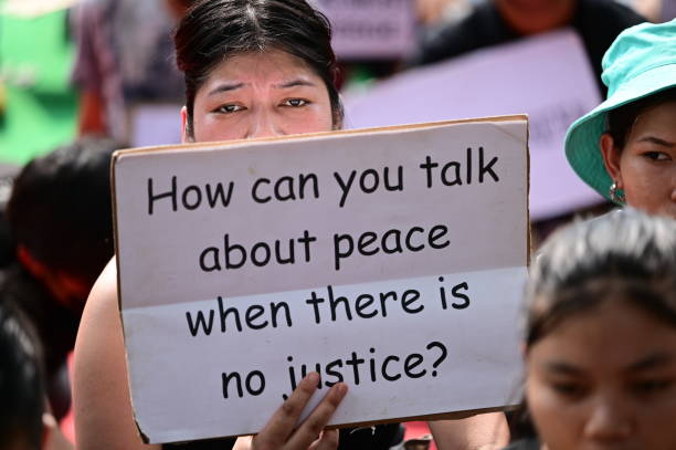 Manipur girl asking by Play card how to make peace here where no Justice 