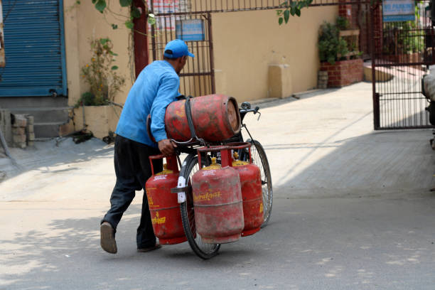 gettyimages-2165080479-612x612 Delivery Boy carrying gas cylinders by bicycle.
