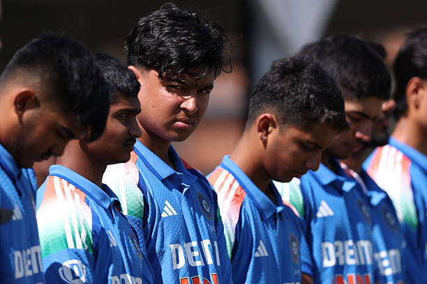 Vaibhav Suryavanshi in blue with India under 19 players in the ground